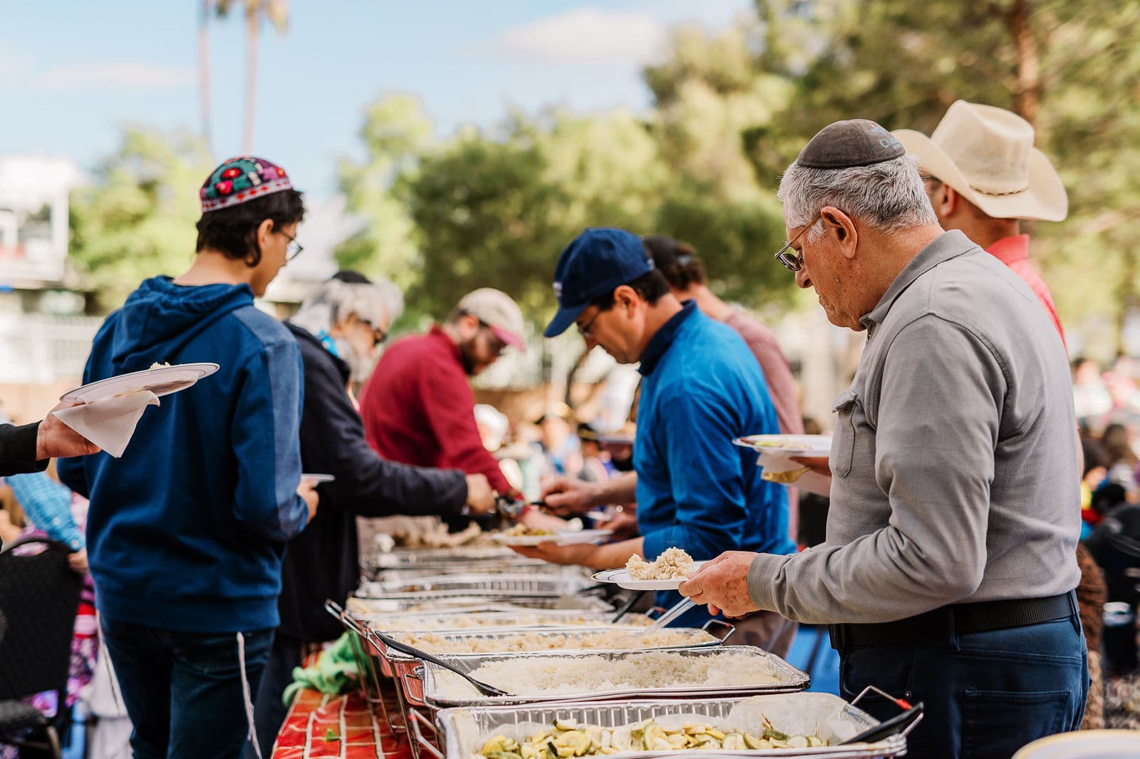 Members serving themselves from the buffet at a community meal