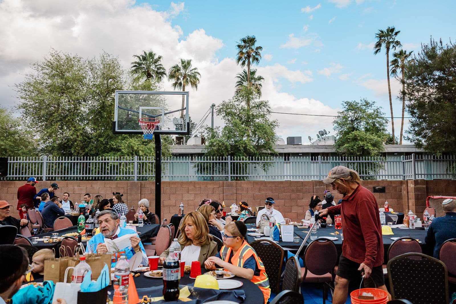 The Purim seudah under an open Phoenix sky on the campus court