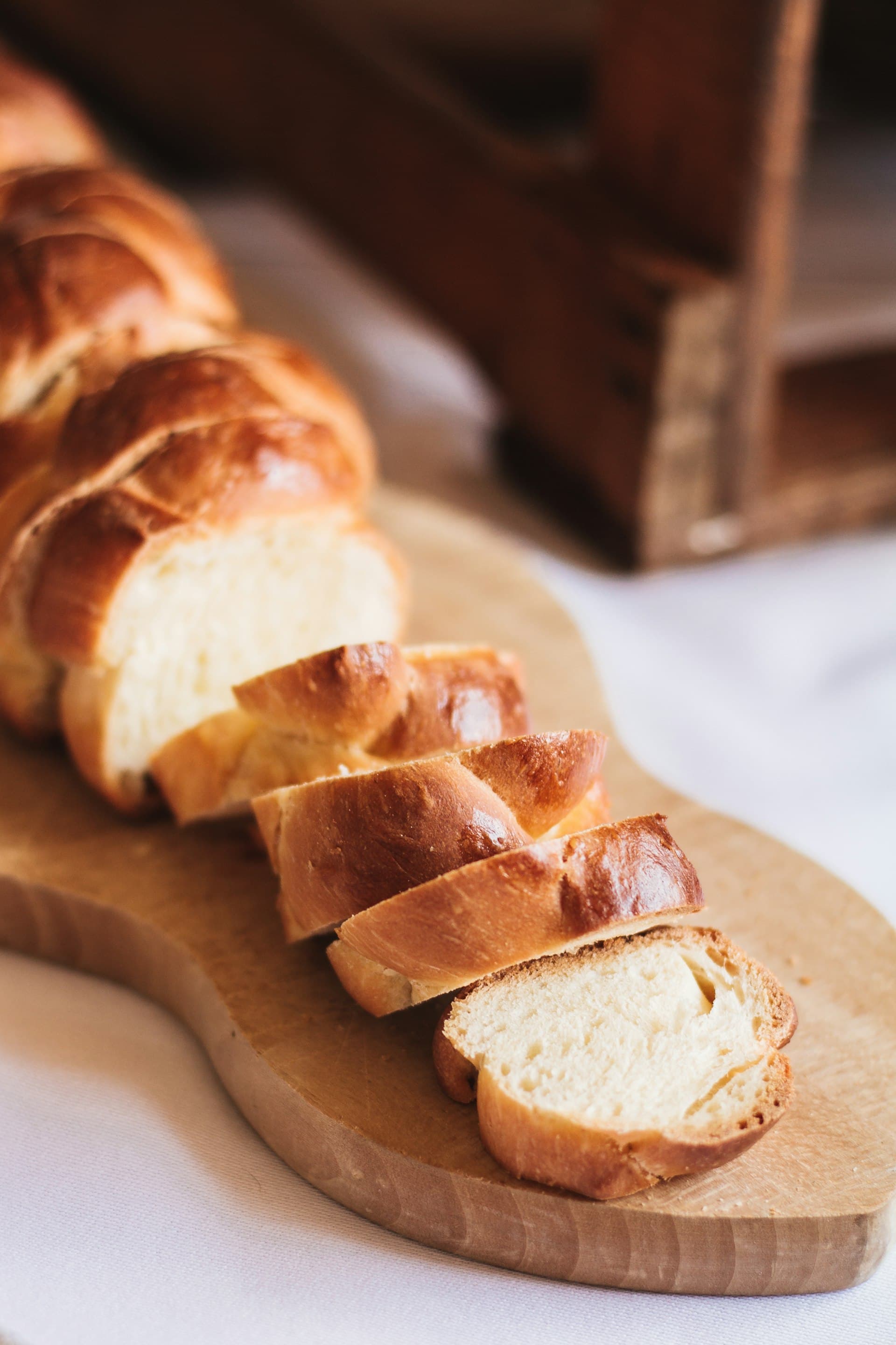 A braided challah on a wooden board