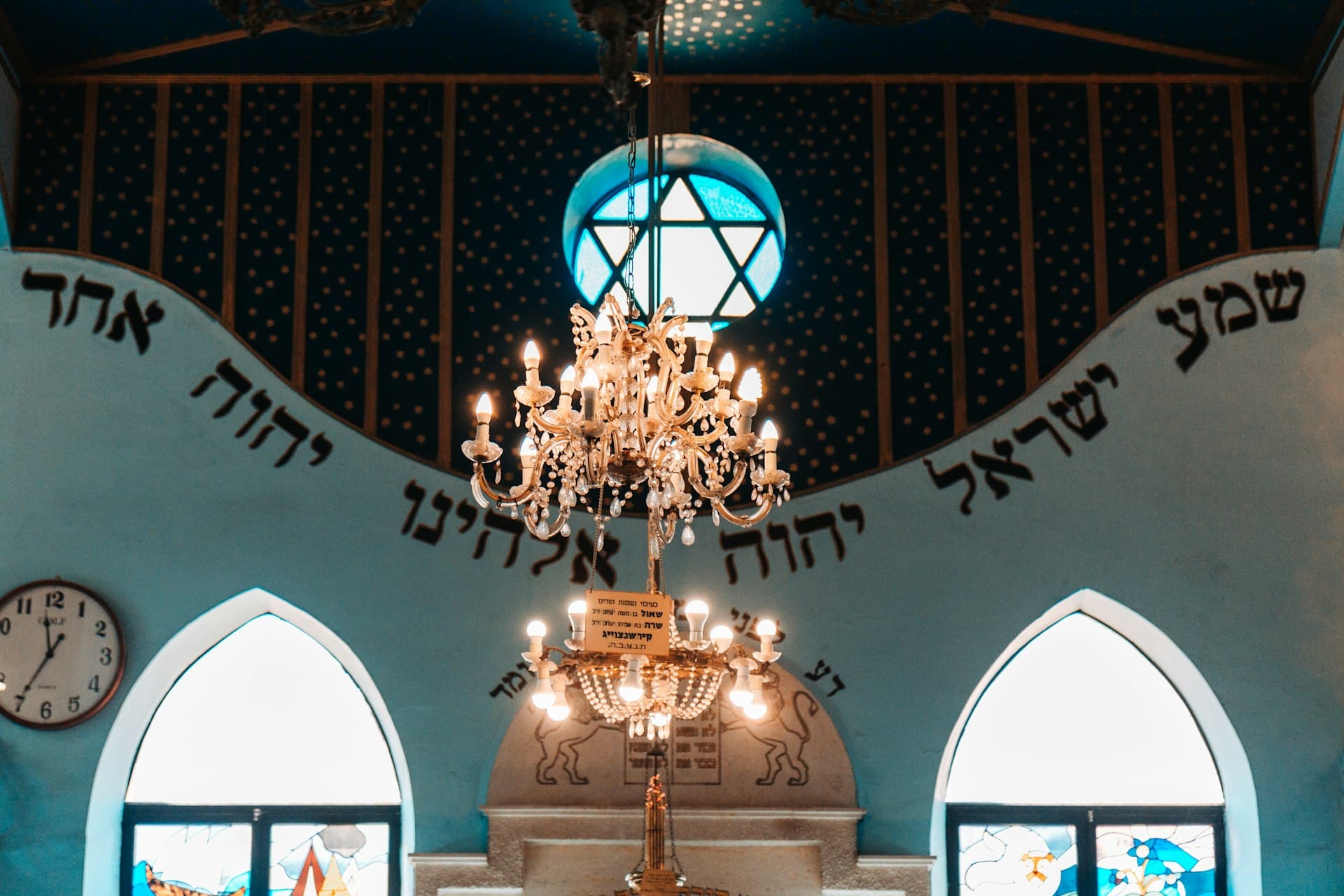 A chandelier glowing in the synagogue